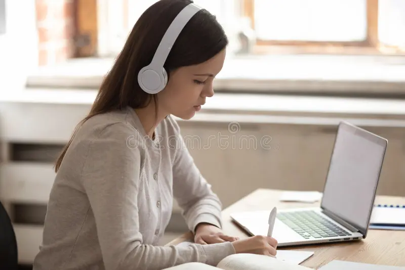 woman listening and taking notes